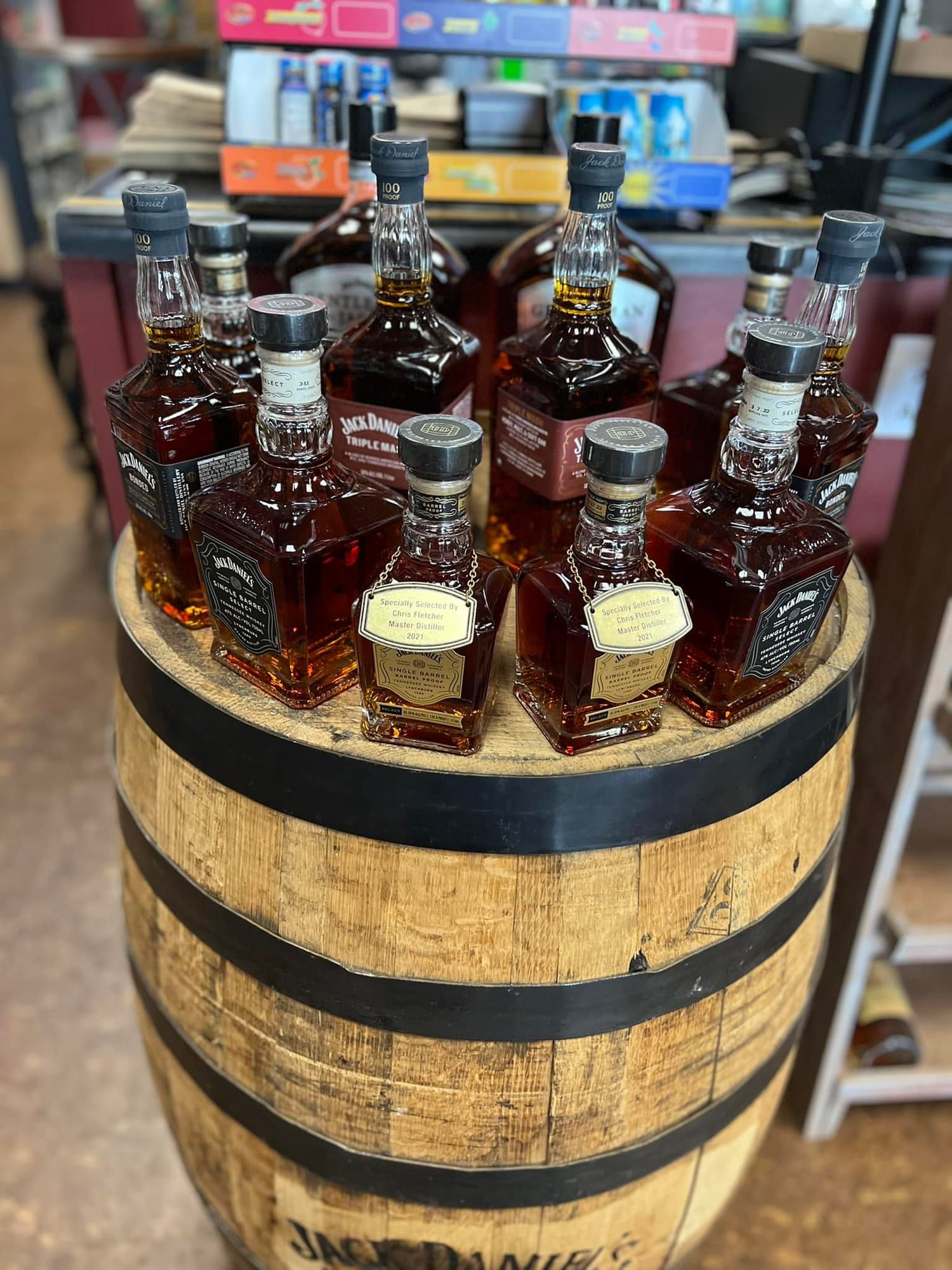 A barrel display stacked with whiskey bottles